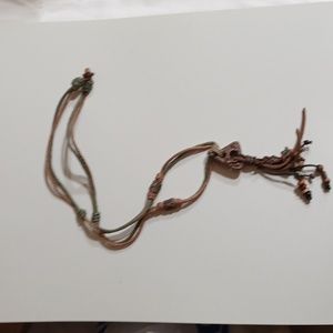 Tribal design necklace with artisan brown rope and leather. 17" L. Brown